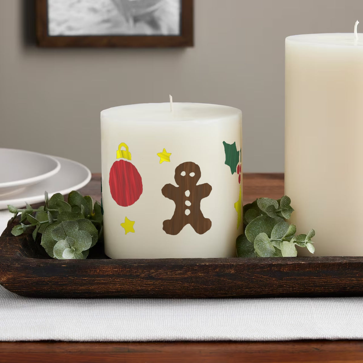 Merry & Bright paint by numbers candle on a table: the finished design painted on an ivory pillar candle