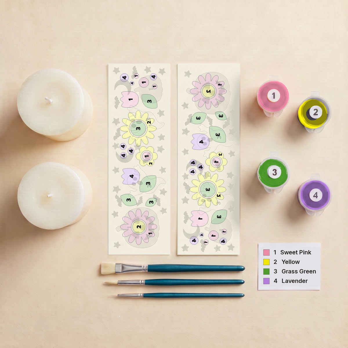 Everything in the Flower Patch kit: two pillar candles, two numbered peel-off wraps, three brushes, four numbered pots of Opaque Candle Paint and the colour key